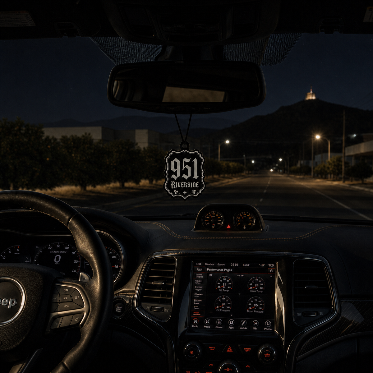 951 Riverside car air freshener in a nighttime car interior