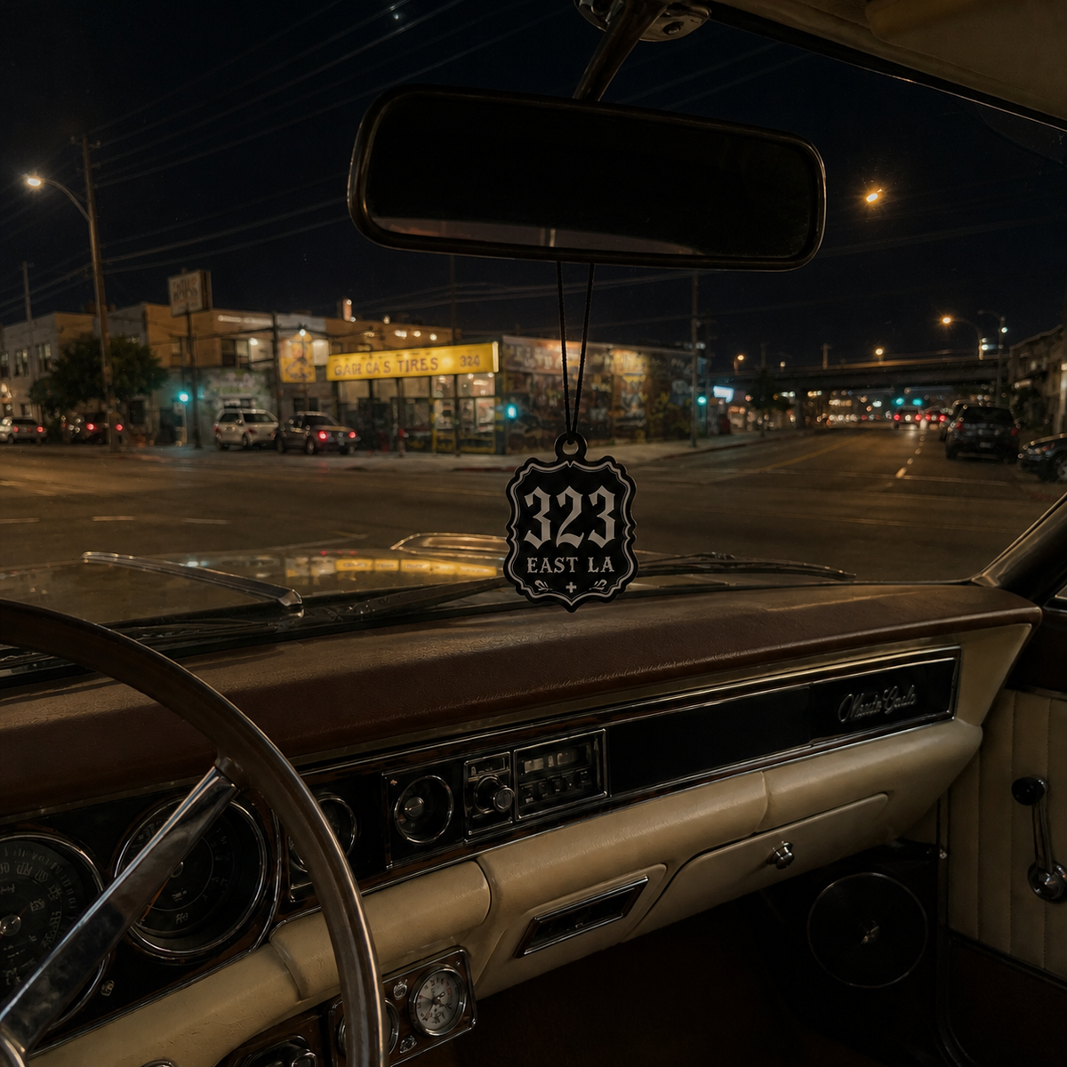 323 East LA car air freshener in a nighttime car interior