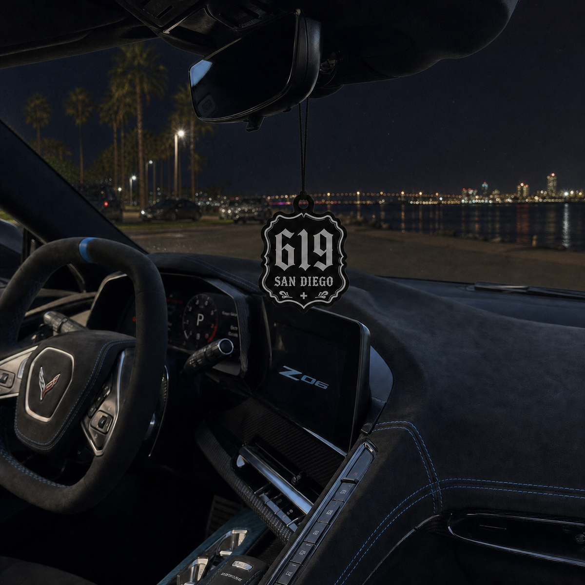 619 San Diego car air freshener in a nighttime car interior
