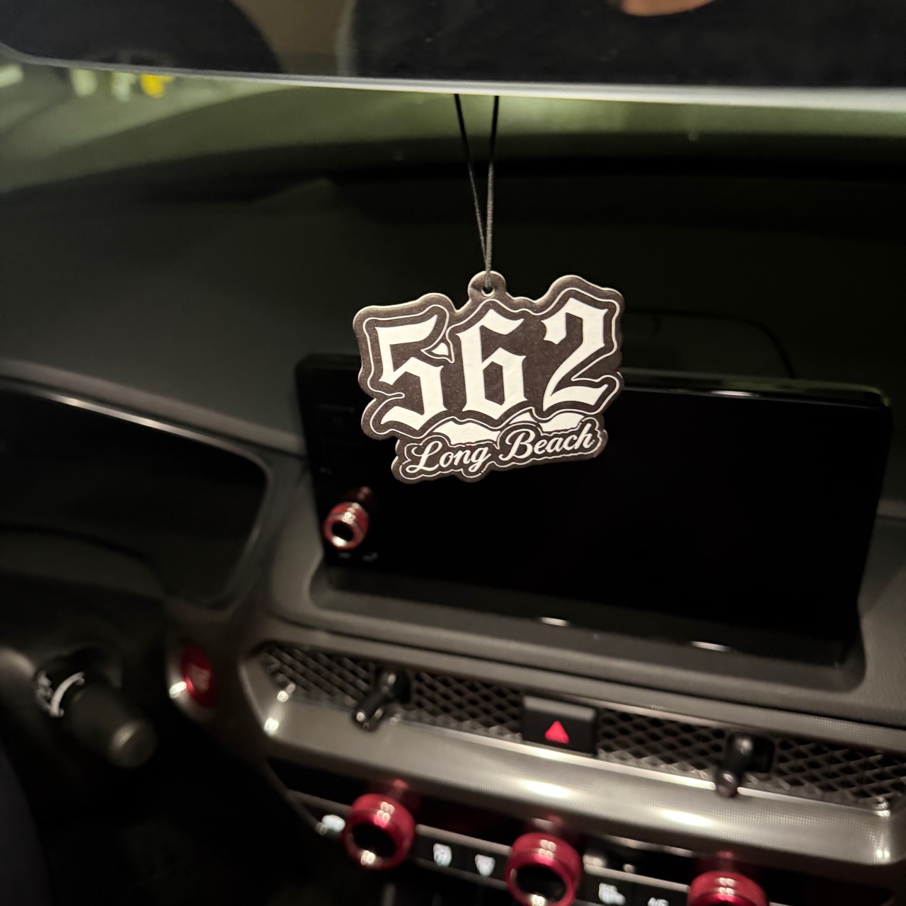 562 Long Beach air freshener hanging inside a car