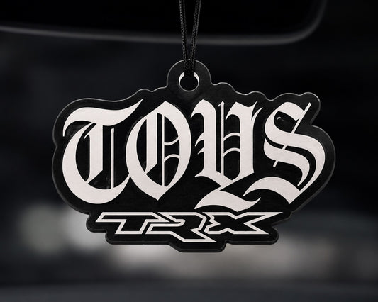 TOYS TRX car air freshener hanging in a car interior