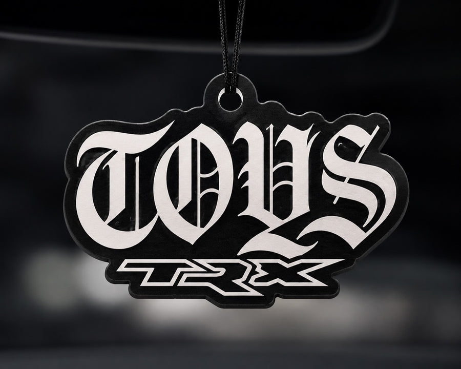 TOYS TRX car air freshener hanging in a car interior