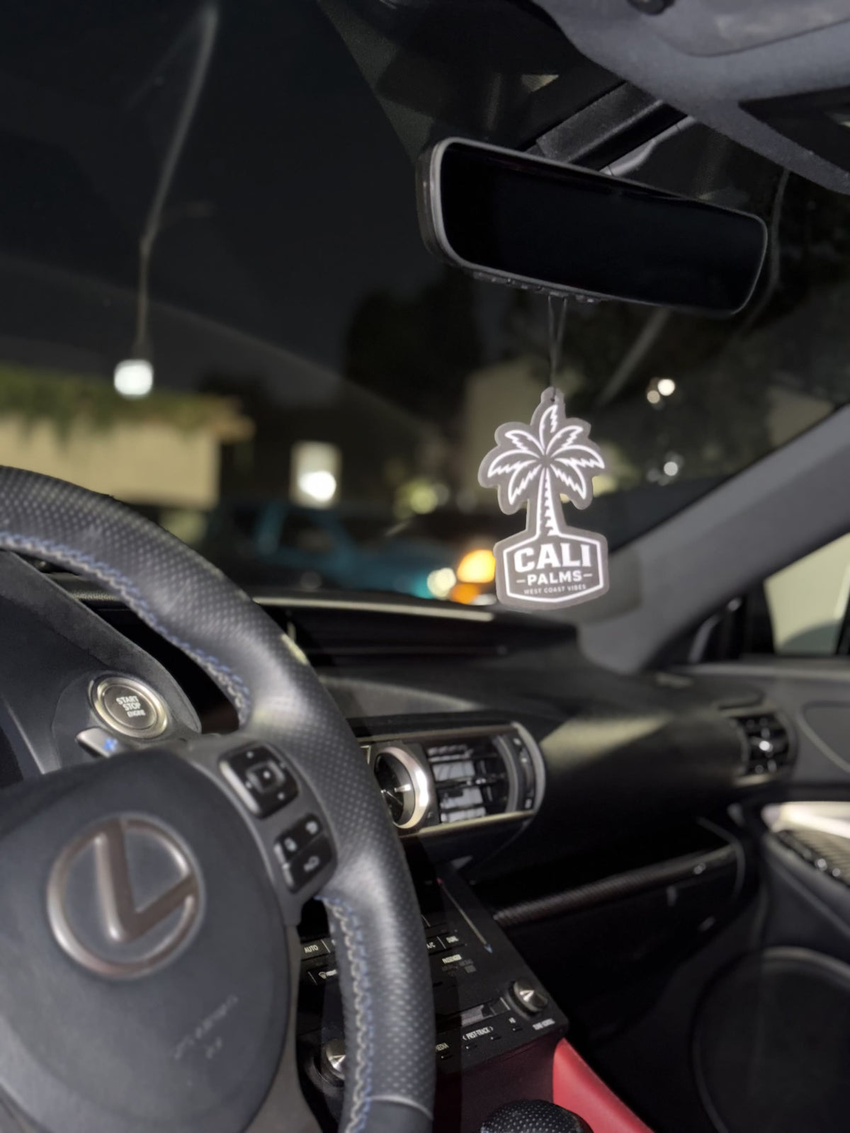 Cali Palms car air freshener displayed inside a Lexus interior