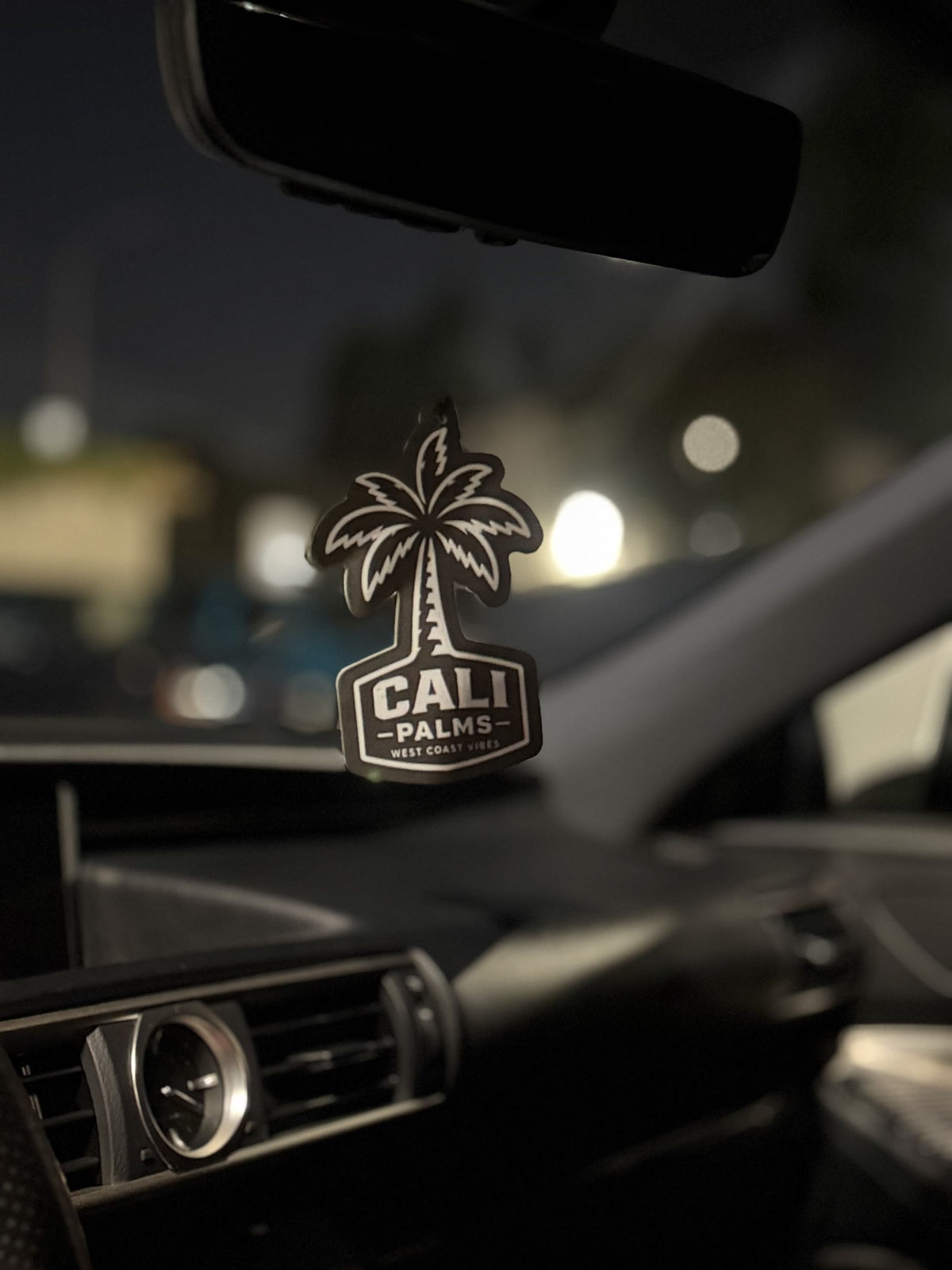 Cali Palms palm tree car air freshener hanging from a rearview mirror