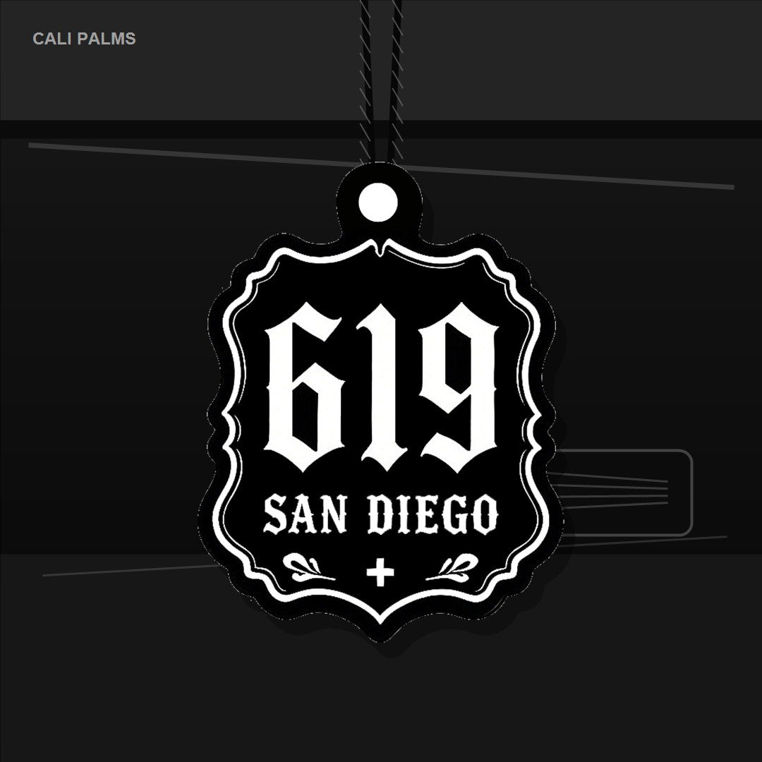 Black Cali Palms 619 San Diego car air freshener hanging from a rearview mirror