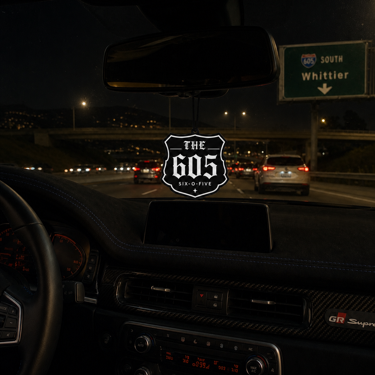 The 605 car air freshener in a nighttime car interior