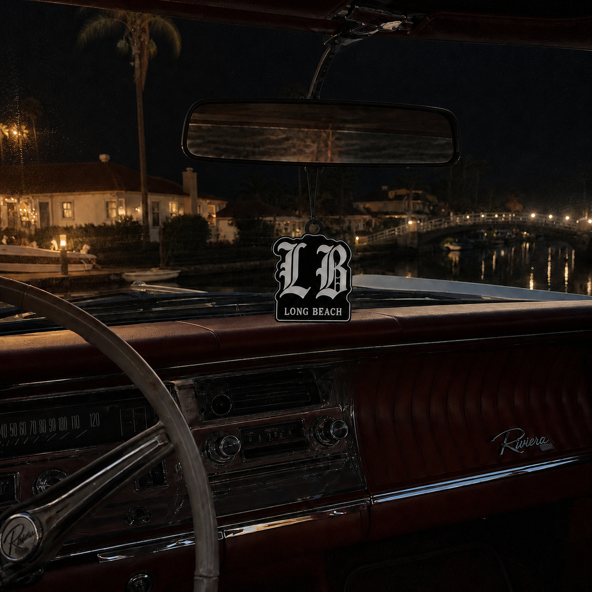 LB Long Beach car air freshener in a nighttime car interior