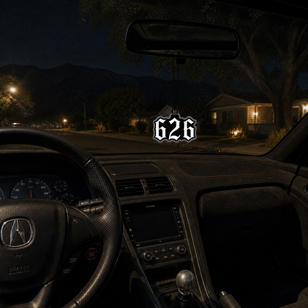 626 San Gabriel Valley car air freshener in a nighttime car interior