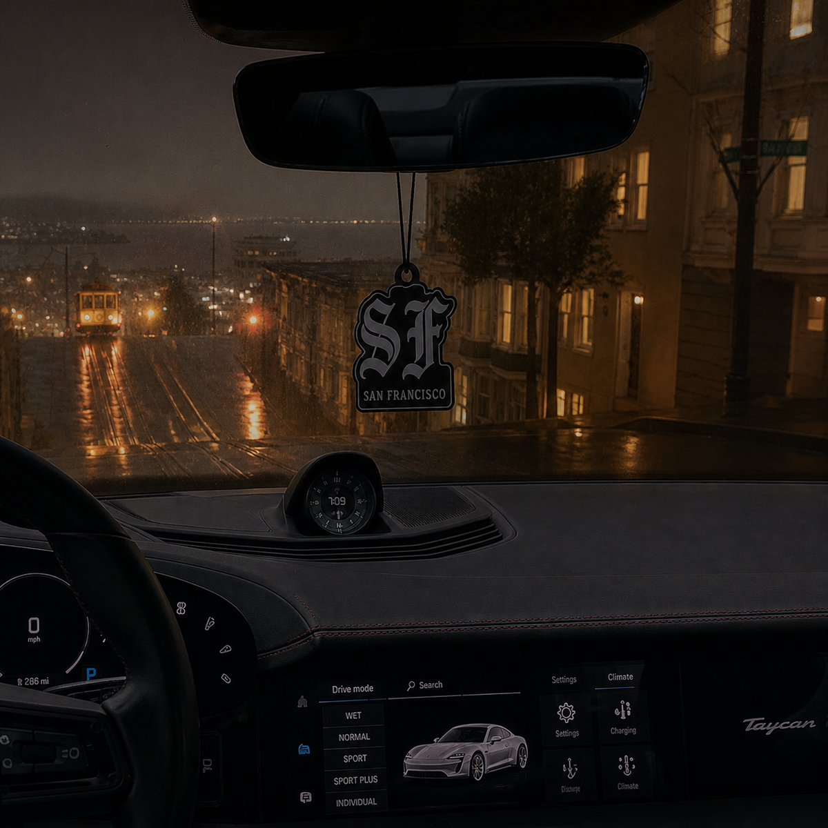 SF San Francisco car air freshener in a nighttime car interior