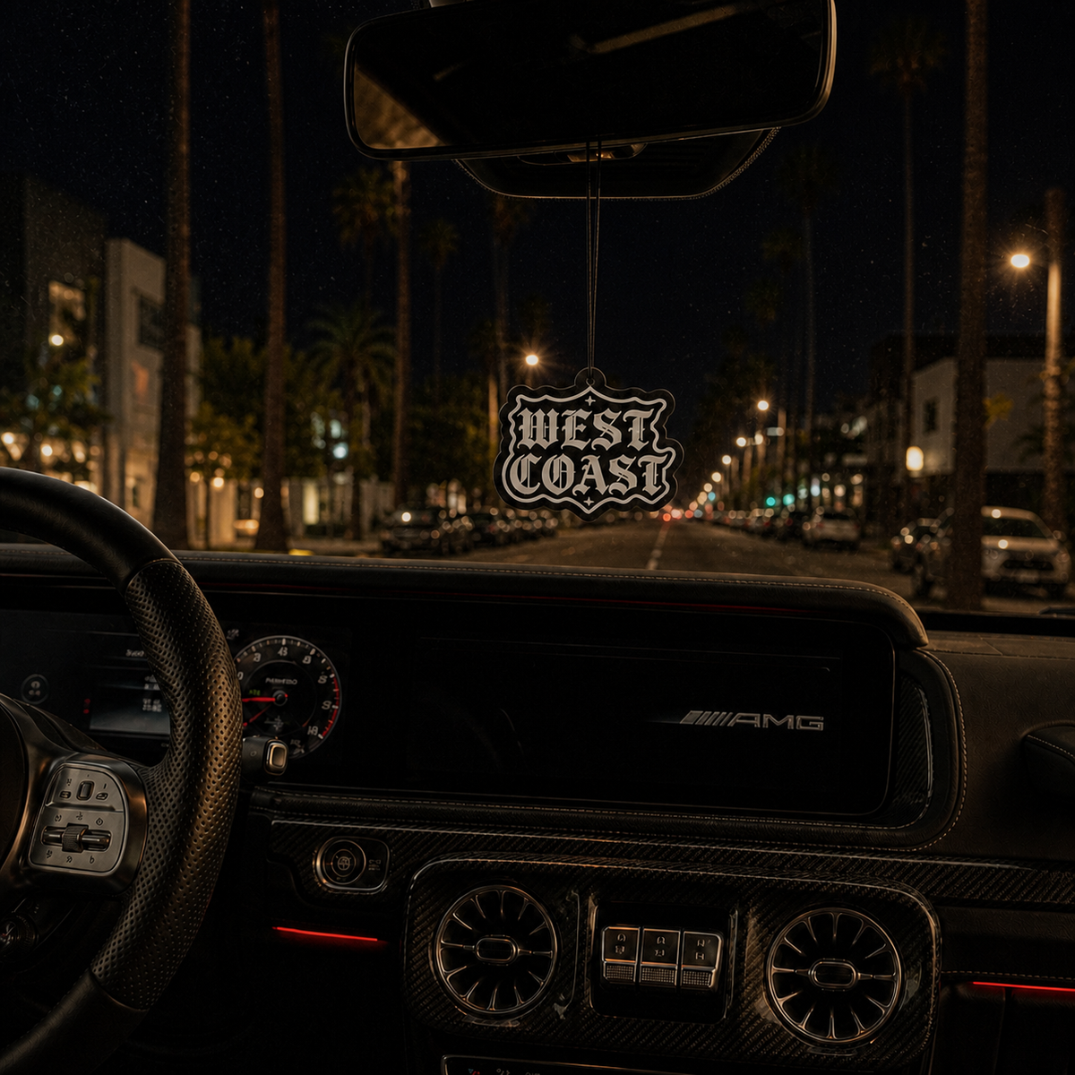West Coast car air freshener in a nighttime car interior