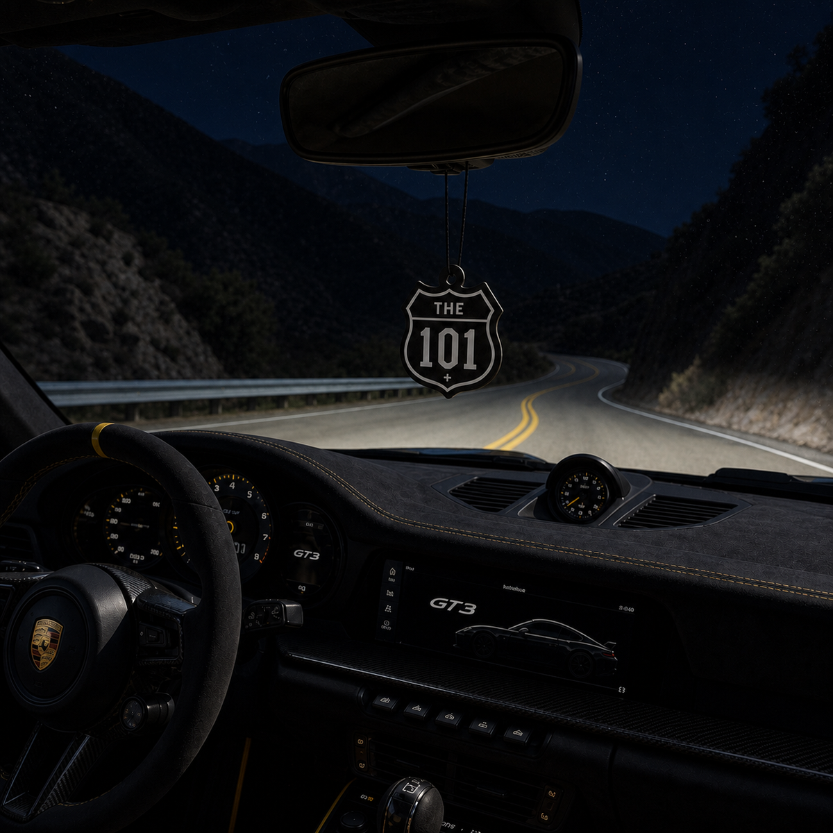 The 101 car air freshener in a nighttime car interior
