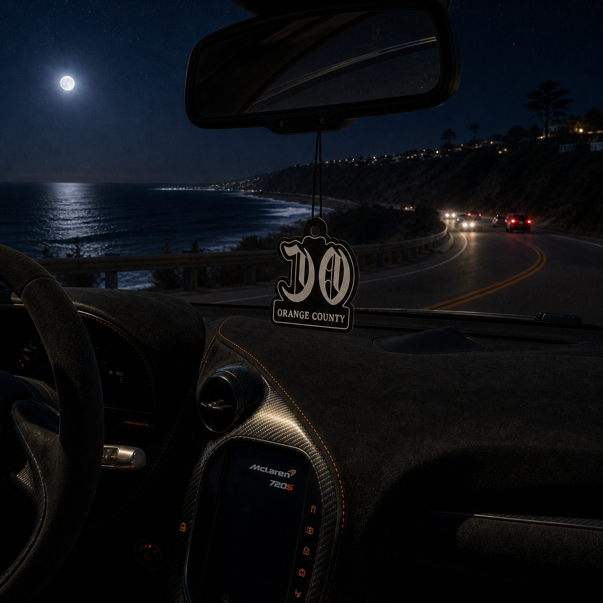 OC Orange County car air freshener in a nighttime car interior